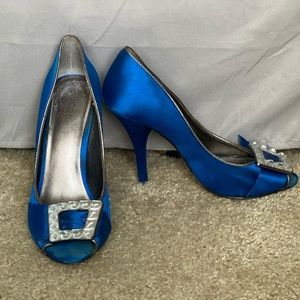 BCBGIRLS satin blue pumps with toe embellishment.